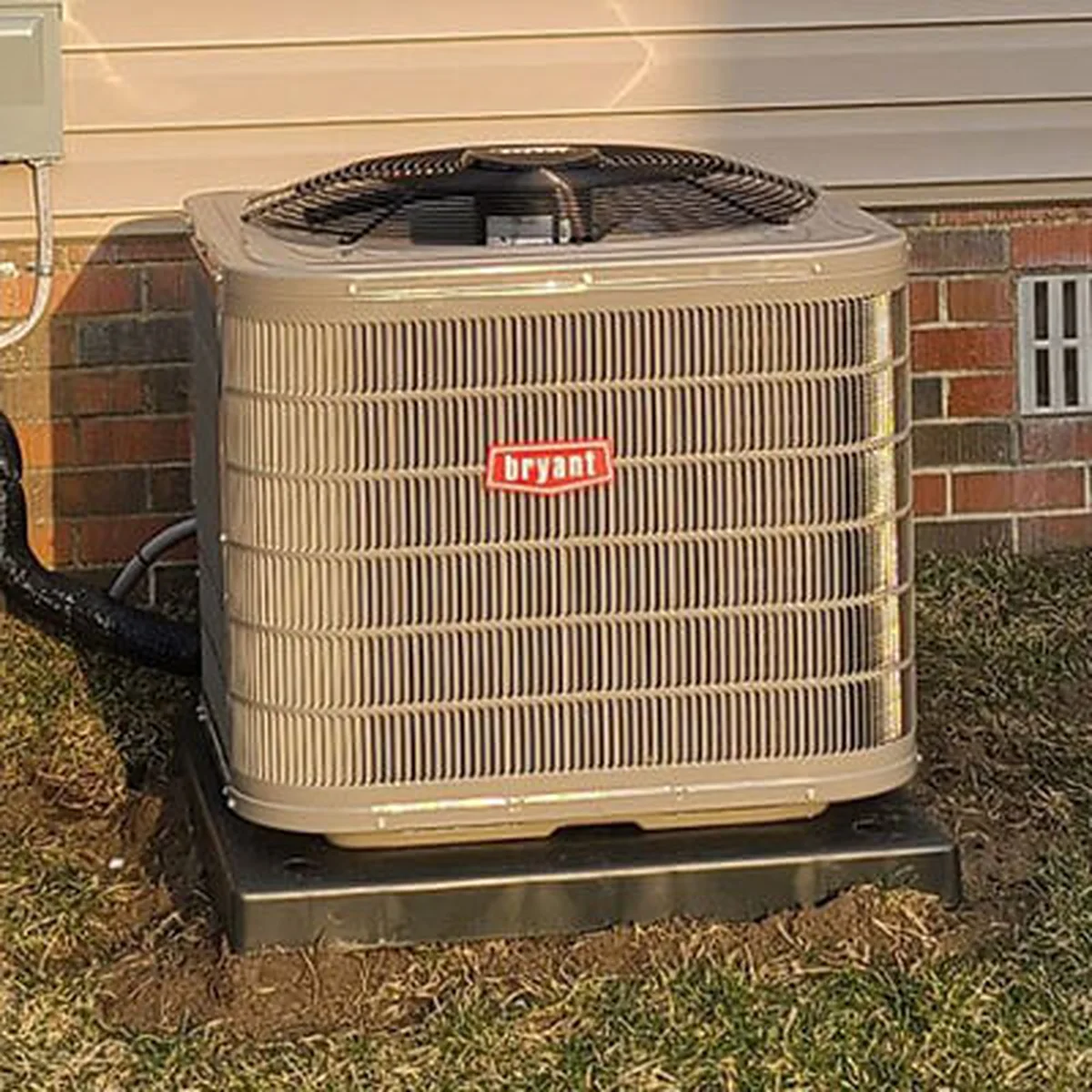 Residential air conditioning condenser unit outside a Michigan home